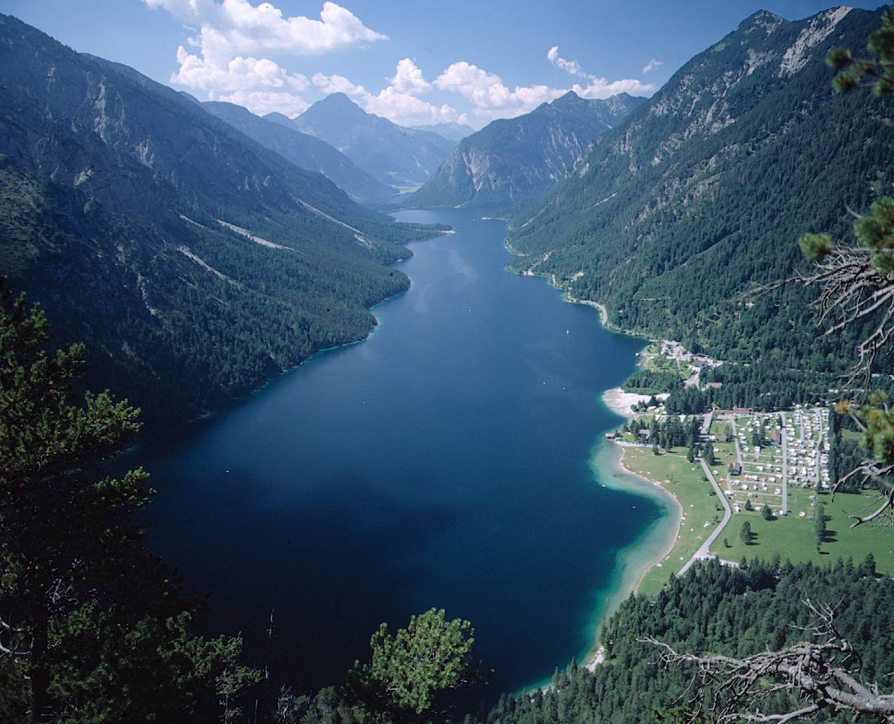 View of the blue Plansee lake with mountain scenery in summer