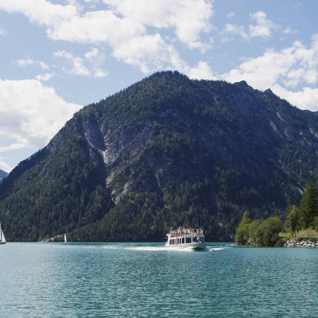 Ship and sailboats on the Plansee in summer
