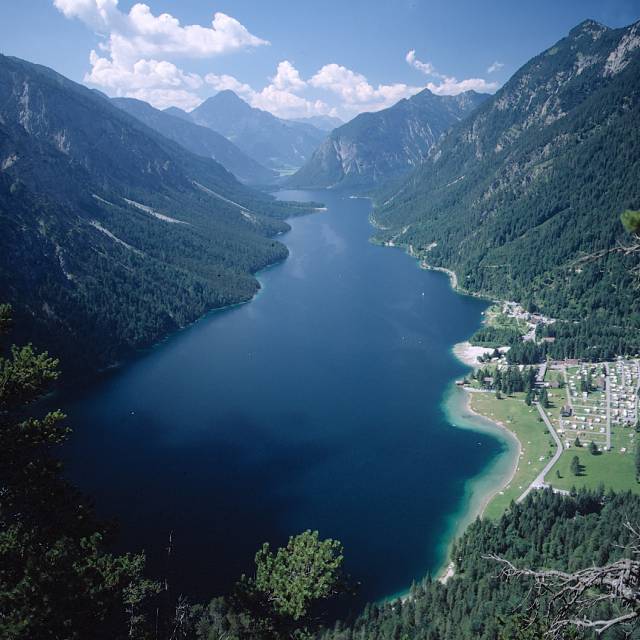 View of the blue Plansee lake with mountain scenery in summer